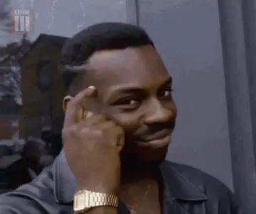 GIF: a man smugly tapping his temple, the “big brain” meme.